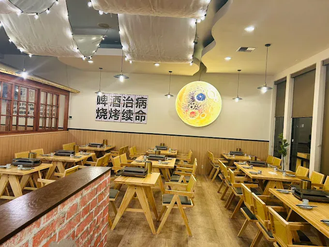 Cozy dining area with wooden tables, chairs, and decorative elements at a restaurant.